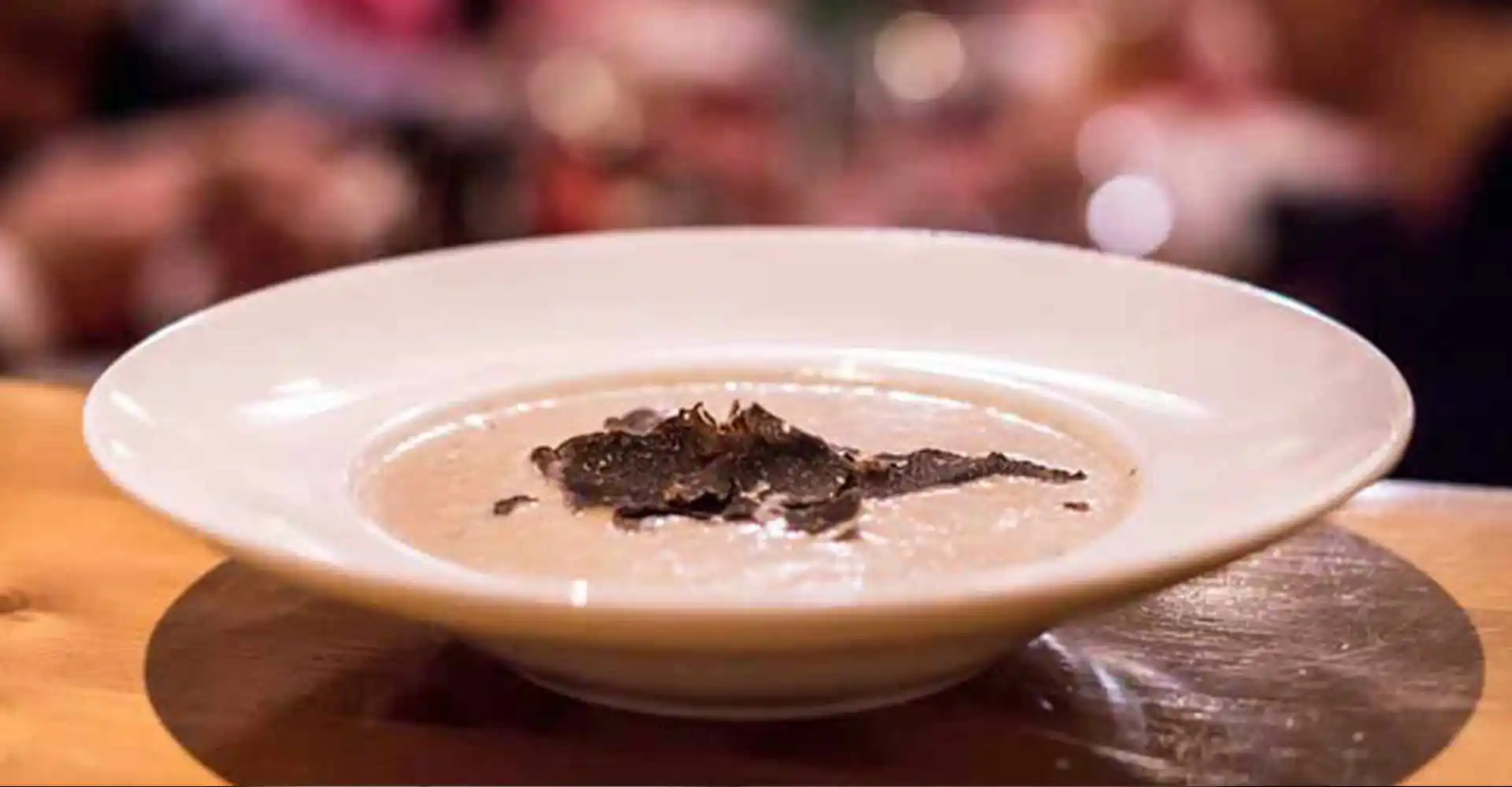 Teller mit Maronencreme-Suppe mit schwarzem Trüffel.